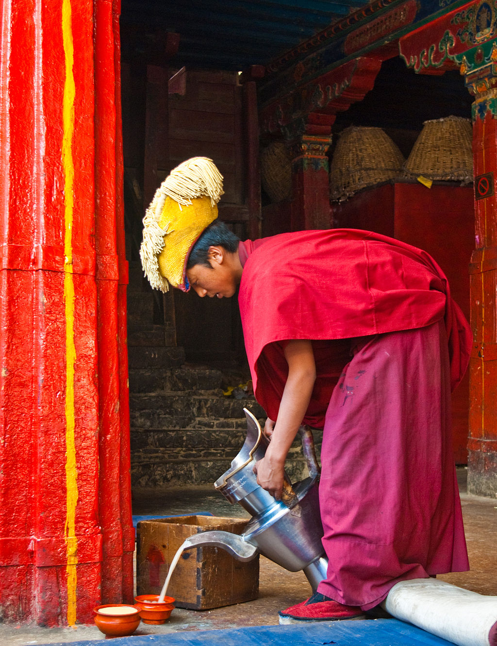 A monk pours butter tea in Tashilhunpo Monastery, Tibet.